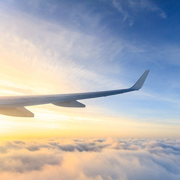 Aircraft wing on sunny but cloudy day stock photo