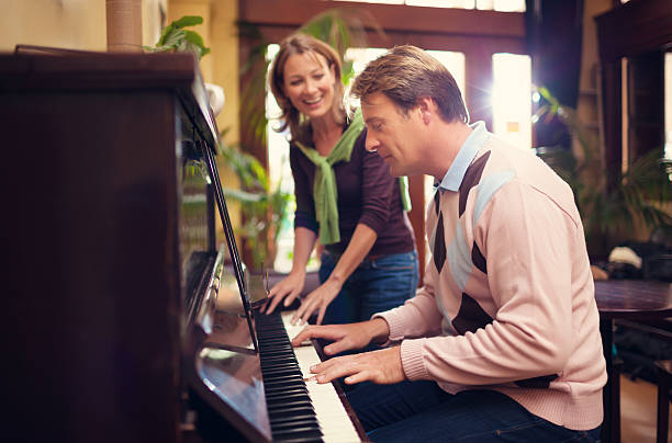 istock couple playing the piano 469892233