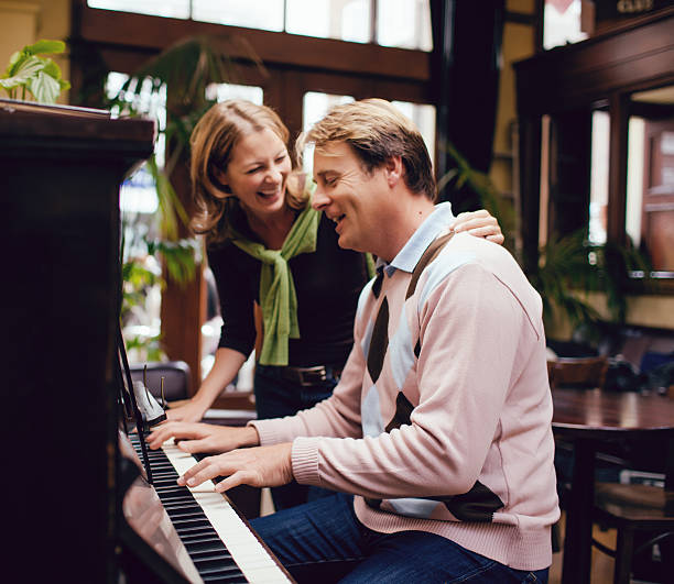 istock couple playing the piano 469892265