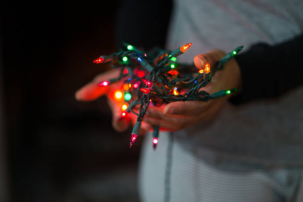istock Hand Holding Christmas Lights 469892629