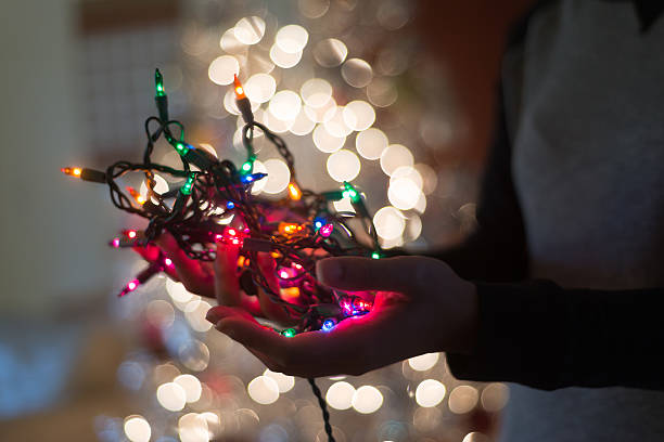 istock Hand Holding Christmas Lights 469892713