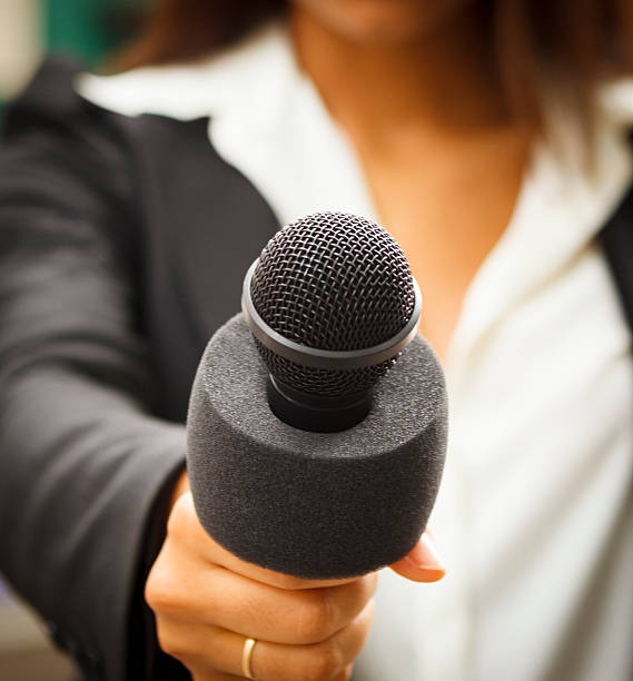 istock Microphone Held by Female Reporter Close-up 469893905