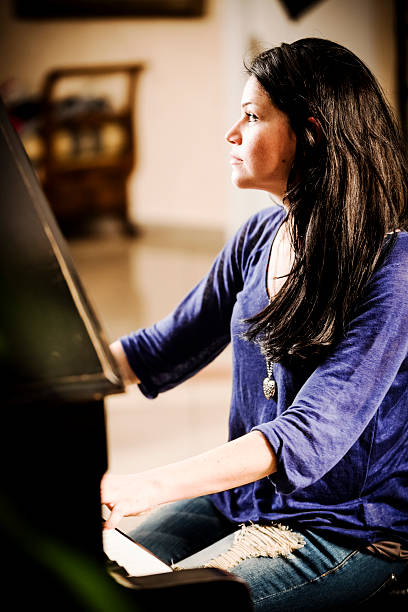 istock Woman Playing Piano 469894183