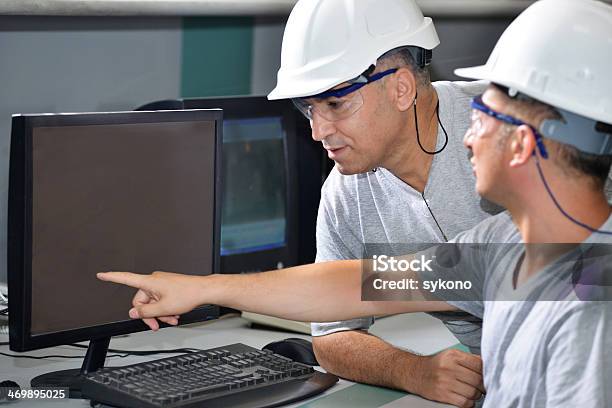 Discussing About New Safety System In Factory Stock Photo - Download Image Now - Engineer, Using Computer, Adult