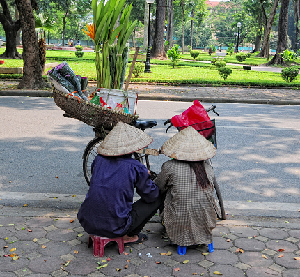 senior woman and man selling vegetables on street in central vietnam village