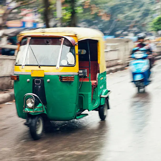 Blurred motion of a moving tuk tuk in Old Delhi, India.