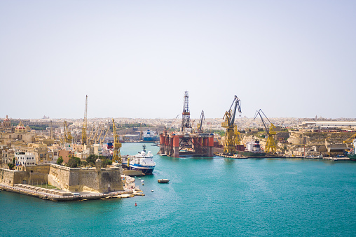 Large industrial oil and gas drilling equipment floating in the Rinella Bay. You can also see the city of Kalkara.