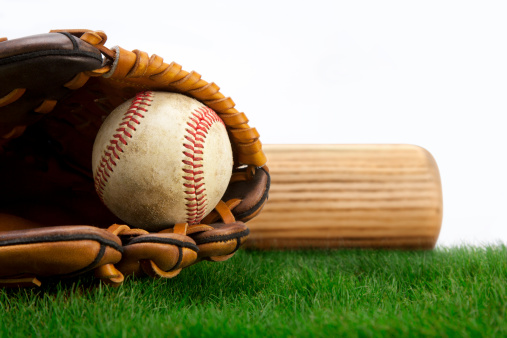 Baseball, glove and bat on grass with white background.