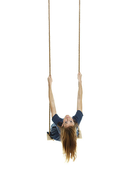 istock Woman swinging on a rope swing 469899547