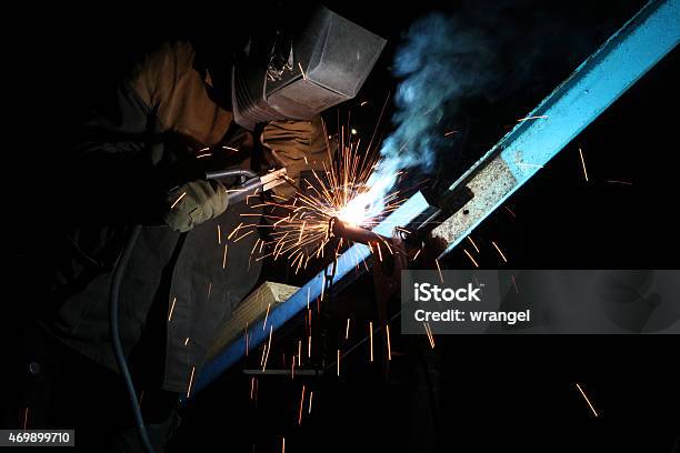 Welding Operator Welds Metal Constructions Stock Photo - Download Image Now - 2015, Blue-collar Worker, Bonding