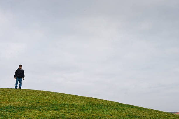 istock Young boy on a dune-Horizon over green grass 469900116