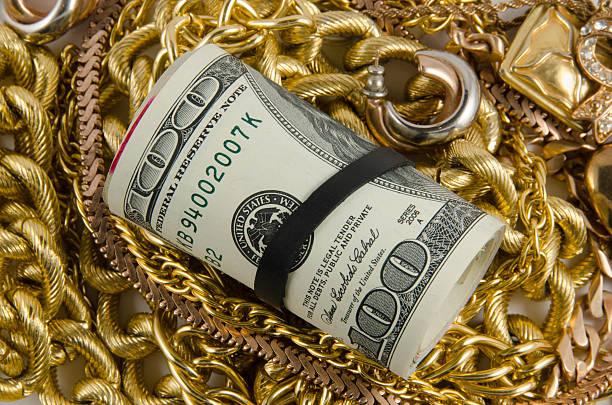 istock dollars with gold on white background 469900386