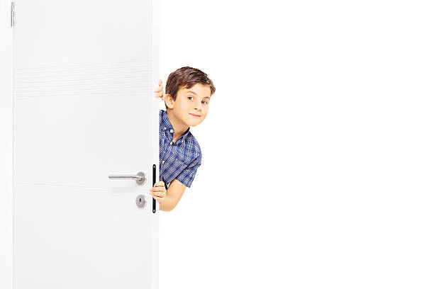 istock Lovely little boy sneaking a peek behind a door 469901216