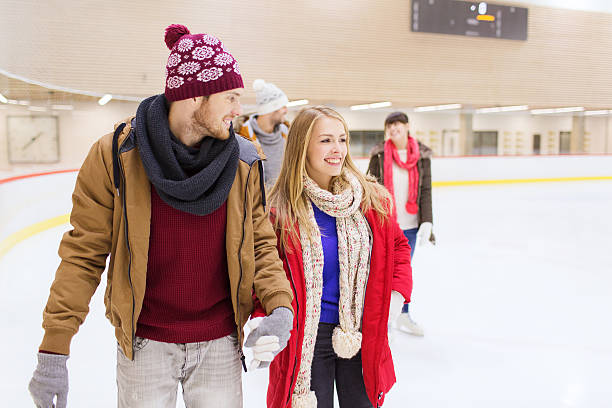 istock Happy couple holding hands on a ice skating rink 469902020