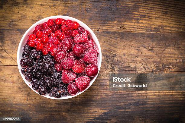 Frozen Berries In Plate On Wooden Background Stock Photo - Download Image Now - 2015, Backgrounds, Berry