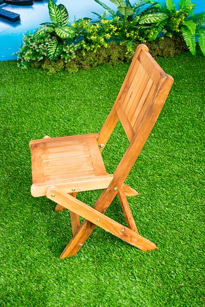istock Red chair on green grass texture 469902498