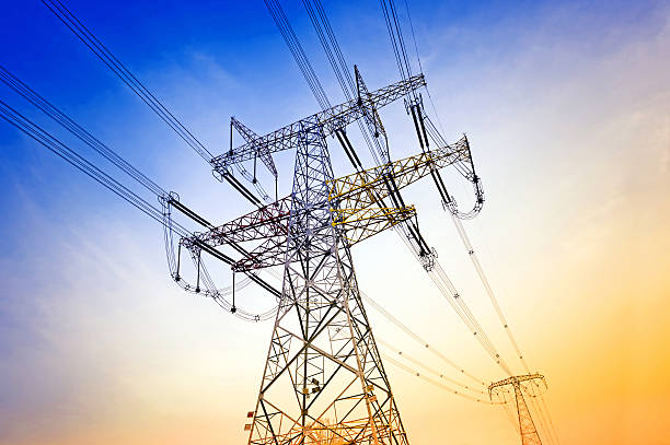 istock An up shot of a wire tower against the setting sun 469903030