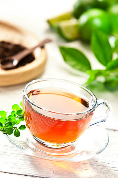 istock Glass cup of hot tea on garden table 469903790