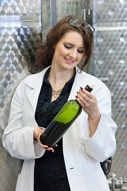 istock Manageress with a smile viewing a bottle of white wine. 469903806