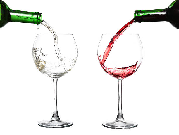 istock White wine pouring from the bottle intro the glass 469904908