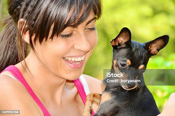 Beautiful Girl Hugging Her Black Pincher Stock Photo - Download Image Now - 2015, Adult, Animal