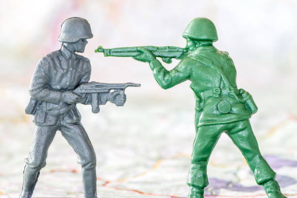 istock Armed duel combat between gray and green soldier toy figurine 469905954