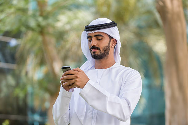 istock UAE National in a park using smart phone 469907024