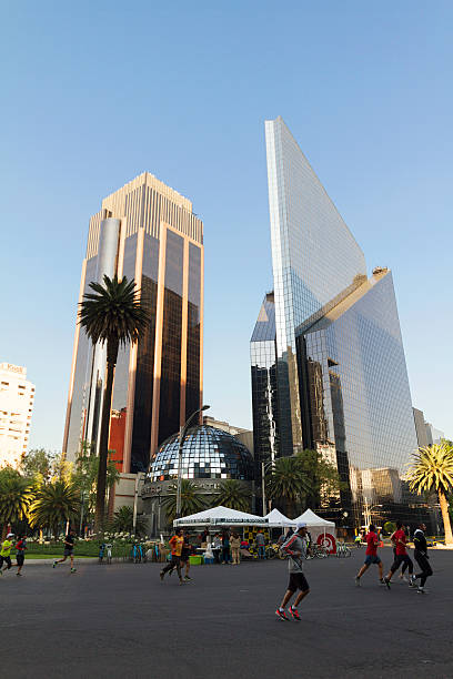 Mexico City, Mexico - February 2, 2014: Bikers at the Mexico City sunday ride along Paseo de la Reforma, in front of the Mexican Stock Exchange building. On sundays the avenue is closed to transit an is full of bikers, runners and families working out or doing outdoors activities.
