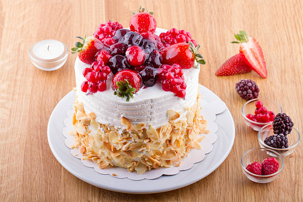 istock Whole White Berry Fruit Cake on Wooden Table 469908254
