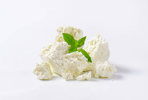 Curd cheese Pieces of curd cheese on white background cottage cheese photos stock pictures, royalty-free photos & images