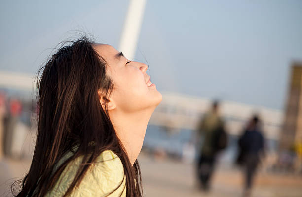 Happy young Asian woman outdoors stock photo