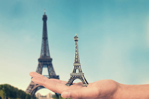 istock Hand holding an Eiffel tower souvenir toy, Paris, France 469909736