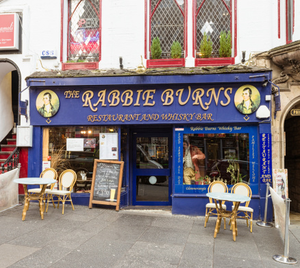 Edinburgh, Scotland, UK - February 4, 2014: The exterior of a restaurant and whisky bar on Edinburgh's Royal Mile, commemorating the 18th Century Scottish poet and lyricist Robert Burns.