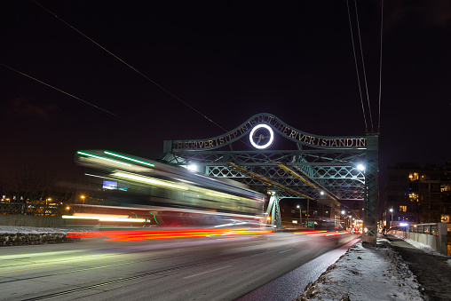 A bridge in East Toronto with the blur of a Streetcar at night