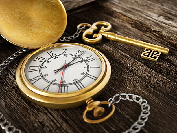 istock Gold antique pocket watch with silver chain on wood surface 469913176
