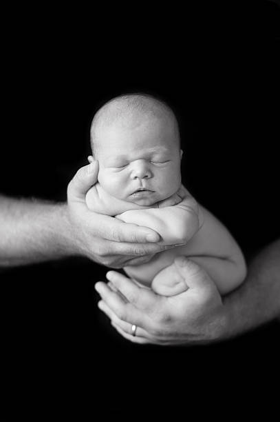 istock Father Holding Newborn Girl 469914449