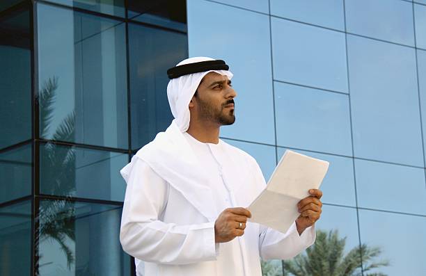 istock Emirati business man holding papers 469915768