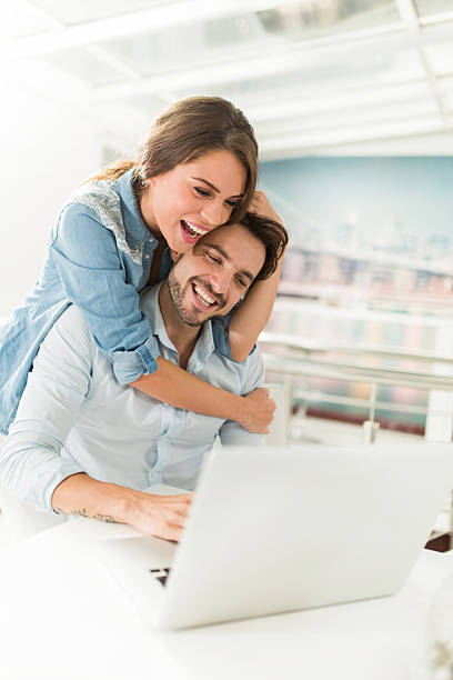 istock Embraced young couple using laptop at home. 469916092