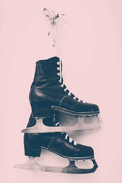 Female hanging ice skates, monochrome toned image with some texture.