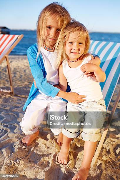 Affectionate Little Sisters Stock Photo - Download Image Now - 2015, Affectionate, Beach