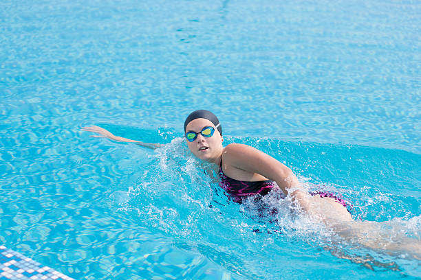 istock Woman in goggles swimming front crawl style 469917258