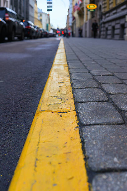 istock Yellow line between the sidewalk and the road 469917324