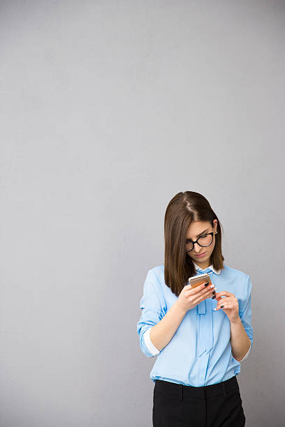istock Young businesswoman using smartphone 469917568