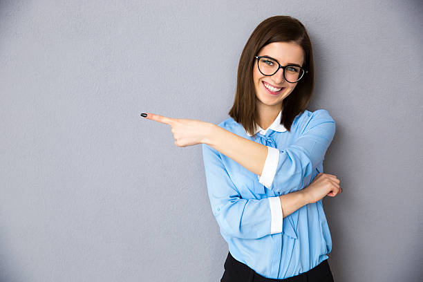 istock Happy businesswoman pointing away 469917594