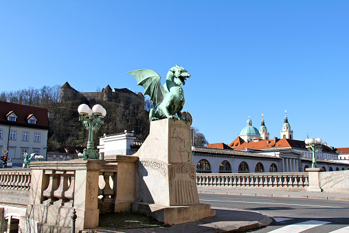 The Dragon Bridge of Ljubljana, Slovenia with the Ljubljana Castle and St. Nicholas Cathedral in the background.