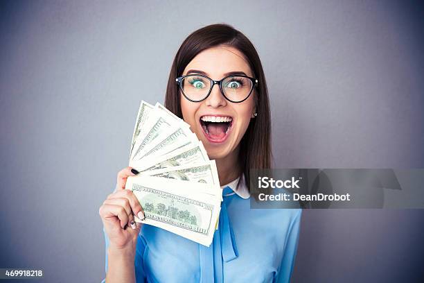 Businesswoman Holding Bill Of Dollars And Shouting Stock Photo - Download Image Now - Currency, Making, Giving