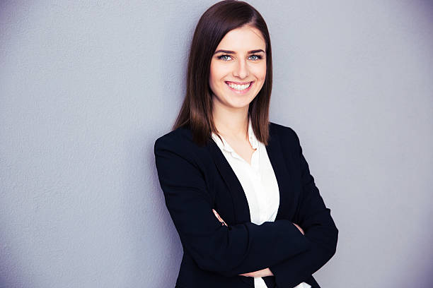 istock Happy young businesswoman with arms folded 469918336