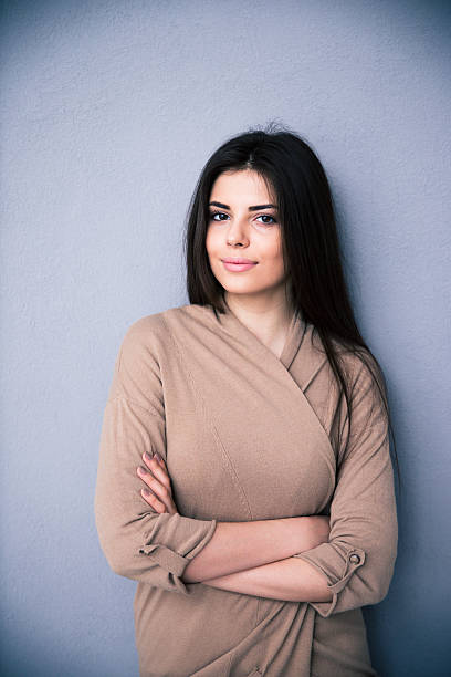 istock Smiling caucasian woman standing with arms folded 469918856