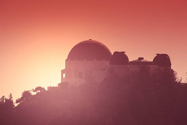 Griffith Park Observatory A view of Griffith Park Observatory in Los Angeles. The Griffith Observatory is a landmark and tourist destination in the Los Angeles and hollywood area. Here is is photographed at sunset. griffith park observatory stock pictures, royalty-free photos & images