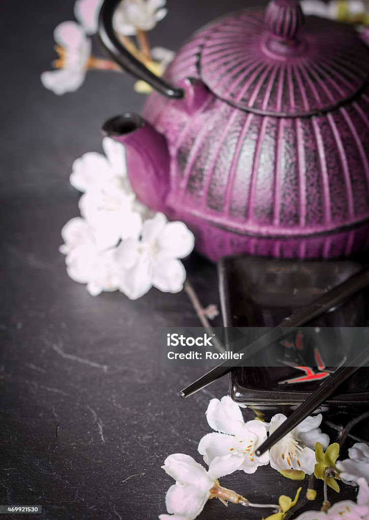Chinese  Set, teapot, chopsticks and sakura branch Chinese  Set, teapot, chopsticks and sakura branch on black background Blossom Stock Photo